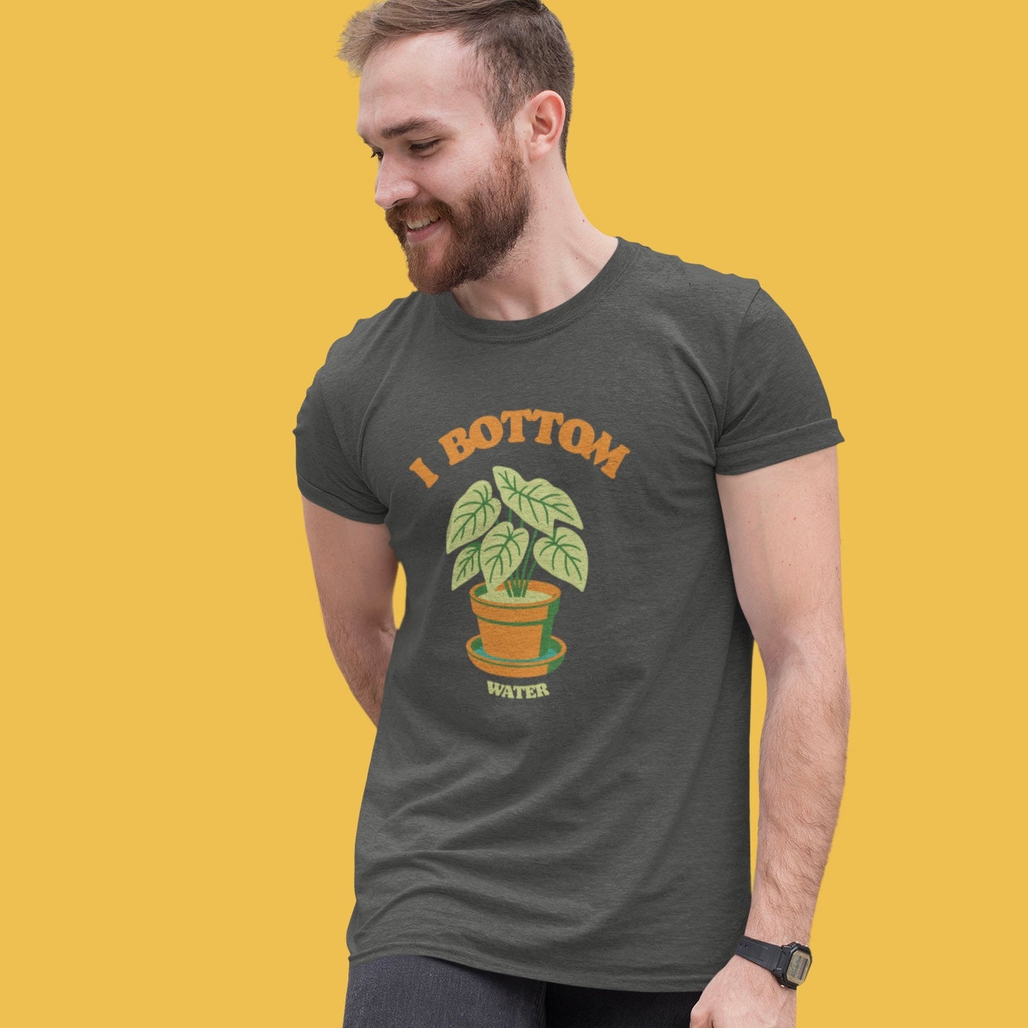 Man wearing a t-shirt with a plant graphic and text on a yellow background